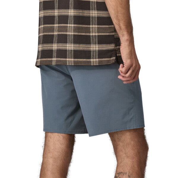 Person wearing Patagonia Men's Hydropeak Hybrid Walk Shorts in grey on a white background.