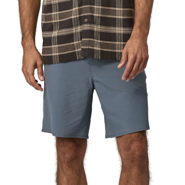 Person wearing Patagonia Men's Hydropeak Hybrid Walk Shorts in grey on a white background.