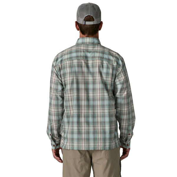 Person wearing the dyno white longshore plaid Patagonia Men's Island Hopper Shirt and tan pants on a white background.