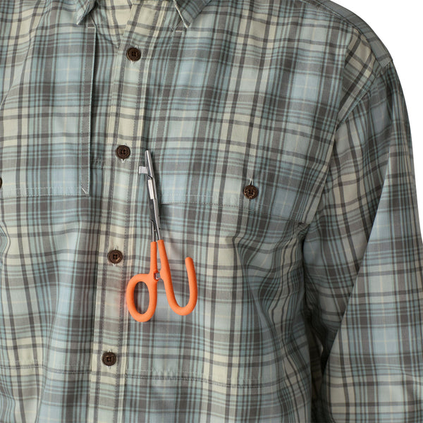 Person wearing the dyno white longshore plaid Patagonia Men's Island Hopper Shirt with a pair of orange-handled hemostats attached to it.