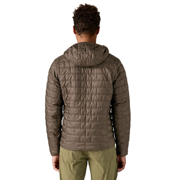 Person wearing the new for 2025 Patagonia Men's Nano Puff Fitz Roy Trout Insulated Hoody in otter brown on a white background.