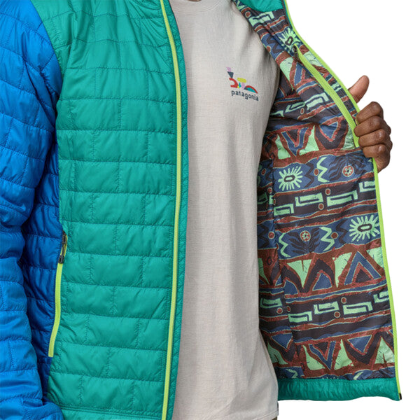 Person wearing a Patagonia Men's Nano Puff Jacket in subtidal blue with a zippered front showing the interior pattern, against a white background.
