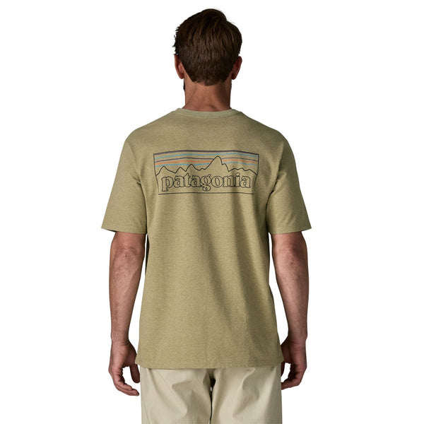 Man wearing a gumtree green Patagonia P-6 Logo t-shirt with a graphic on the back, against a white background.