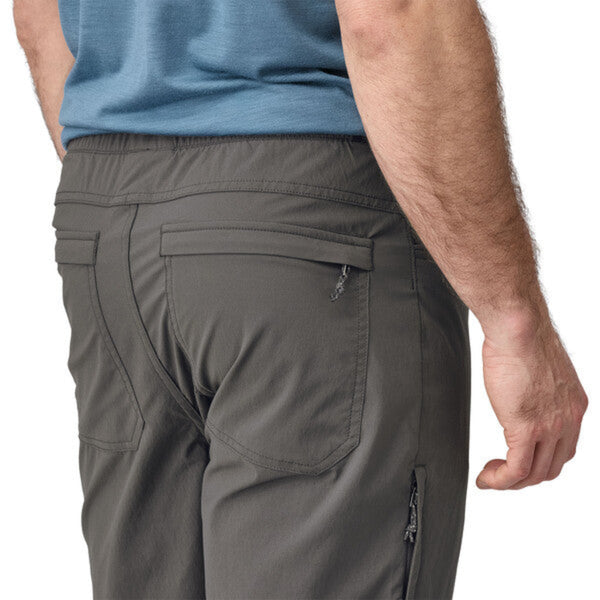 Person wearing Patagonia Men's Quandary Joggers in grey, featuring  pocket details on a white background.
