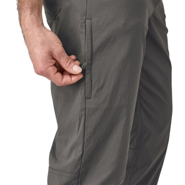 Person wearing Patagonia Men's Quandary Joggers in grey, featuring  pocket details on a white background.