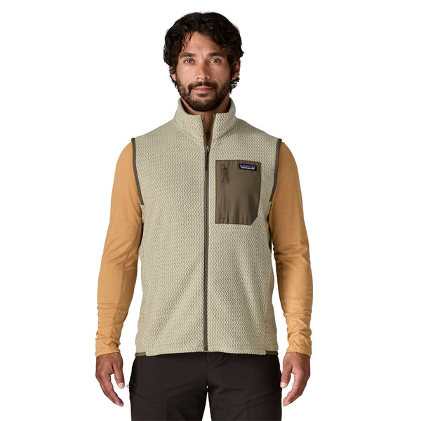 Man wearing a pelican tan Patagonia Men's R1 Air Fleece Vest on a white background.