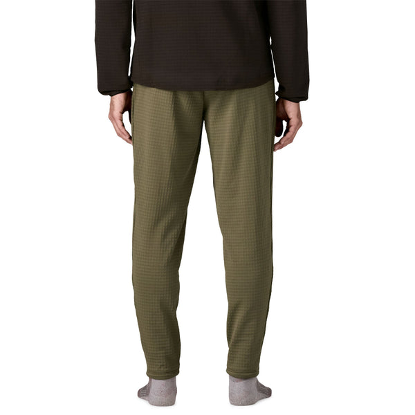 Person wearing basin green Patagonia Men's R1 Fleece Pants on a white background.