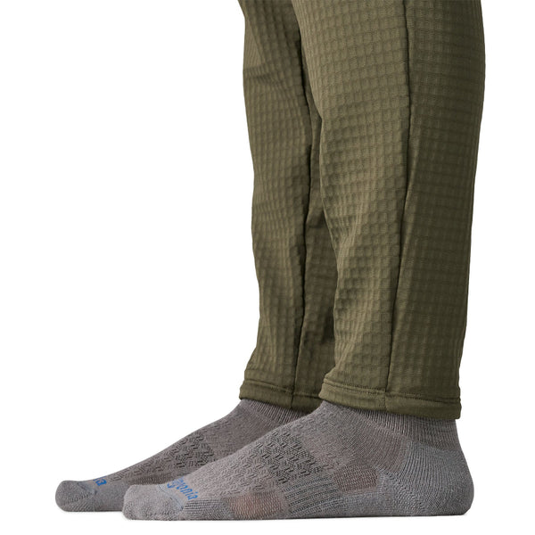 Close up of the cuff details on the basin green Patagonia Men's R1 Fleece Pants, on a white background.