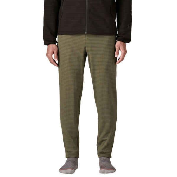 Person wearing basin green Patagonia Men's R1 Fleece Pants on a white background.