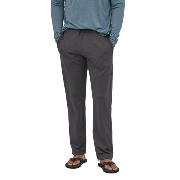 Person wearing the Patagonia Men's R1 Pants in forge grey on a white background.