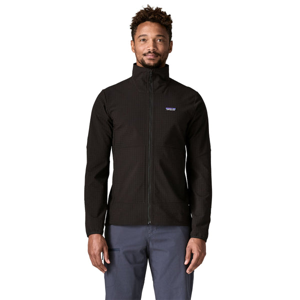 Person wearing a black Patagonia Men's R1 TechFace Jacket and grey pants on a white background.
