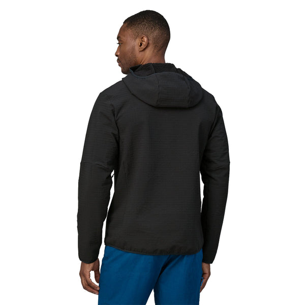 Person wearing the black Patagonia Men's R2 TechFace Full-Zip Hoody and blue pants on a white background.