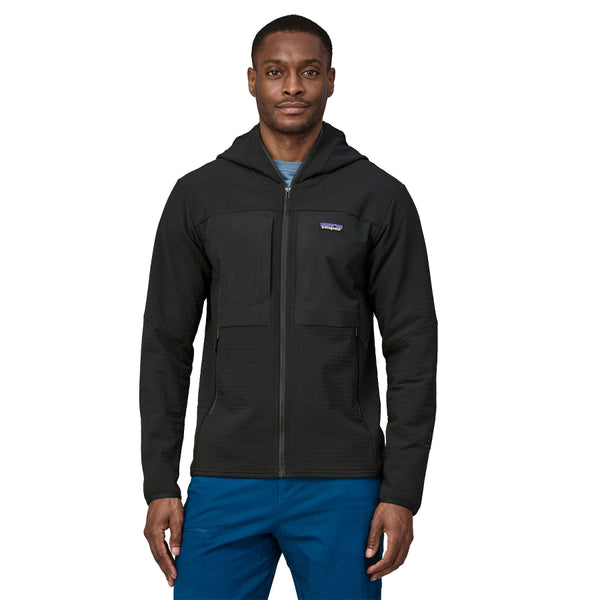 Person wearing the black Patagonia Men's R2 TechFace Full-Zip Hoody and blue pants on a white background.