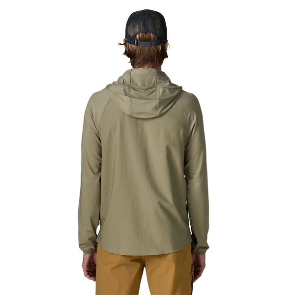 Person wearing brown pants and a men's Patagonia River Rambler Hybrid UPF Sun Hoody in River Rock Green, featuring a removable hood, against a white background.