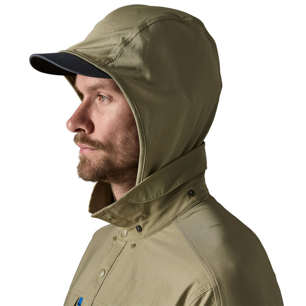 Person wearing the men's Patagonia River Rambler Hybrid UPF Sun Hoody in River Rock Green, featuring a removable hood, against a white background.