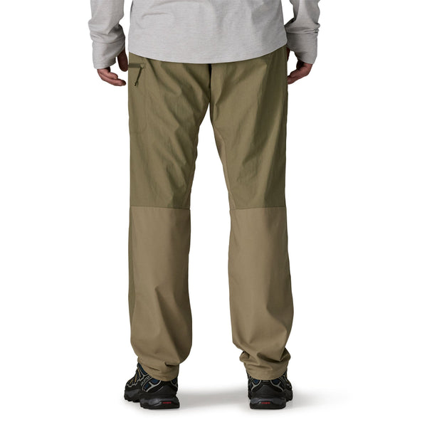 Person wearing sage khaki  Patagonia Men's Sandy Cay Wading Pants on a white background.