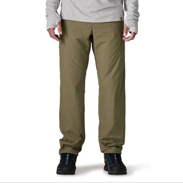 Person wearing sage khaki  Patagonia Men's Sandy Cay Wading Pants on a white background.
