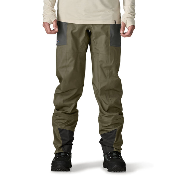Person wearing a set of Patagonia Men's Swiftcurrent Pant Waders in basin green, on a white background.
