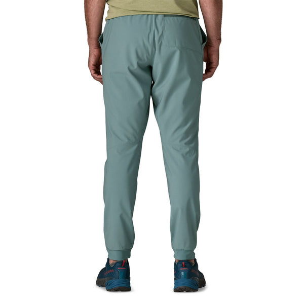 Man wearing Patagonia Men's Terrebonne Joggers in blue sage on a white background.