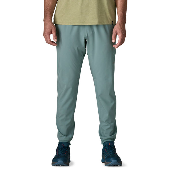 Man wearing Patagonia Men's Terrebonne Joggers in blue sage on a white background.