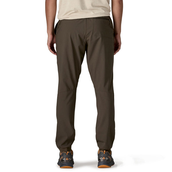 Man wearing Patagonia Men's Terrebonne Joggers in otter brown on a white background.