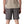 Person wearing forge grey Patagonia Men's Terrebonne Shorts and a beige top on a white background.