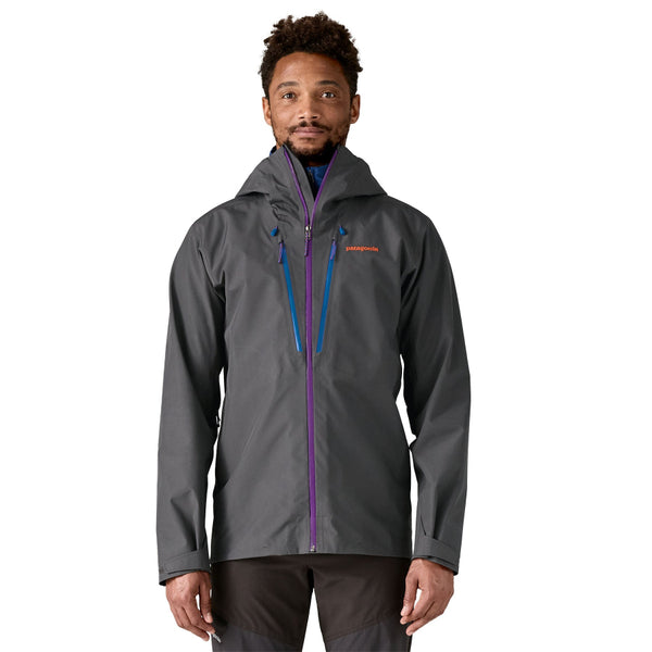 Man wearing the forge grey Patagonia Men's Triolet Alpine Jacket on a white background.