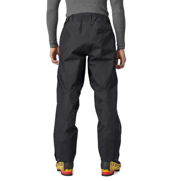 Person wearing black Patagonia Men's Triolet Alpine Pant on a white background.