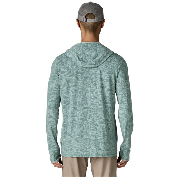 Person wearing khakis and the sea run - sage blue color Patagonia Men's Tropic Comfort Natural Sun Hoody on a white background.