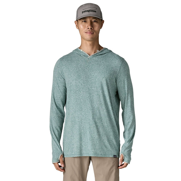 Person wearing khakis and the sea run - sage blue color Patagonia Men's Tropic Comfort Natural Sun Hoody on a white background.
