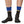 Person wearing Black Patagonia Merino Crew socks with blue top and yellow fitz roy stripe on a white background.