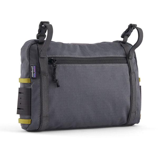 A Patagonia Stealth Switch Pack 3L in forge grey color designed for carrying fishing equipment and showing back side on a white background.