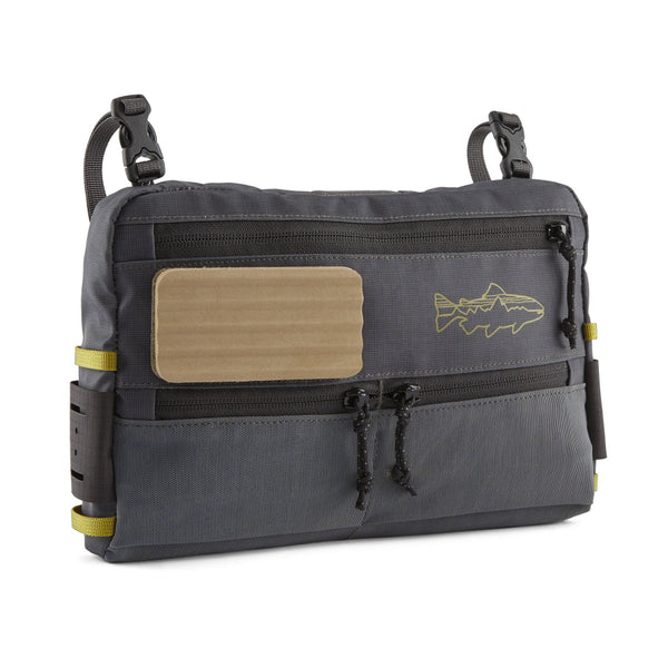 A Patagonia Stealth Switch Pack 3L in forge grey with graze green designed for carrying fishing equipment and showing front side on a white background.