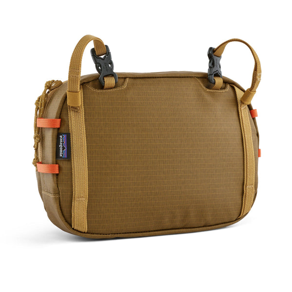 Back side of the Patagonia Stealth Switch Pack 5L in bobcat brown color designed for carrying fishing equipment, on a white background.