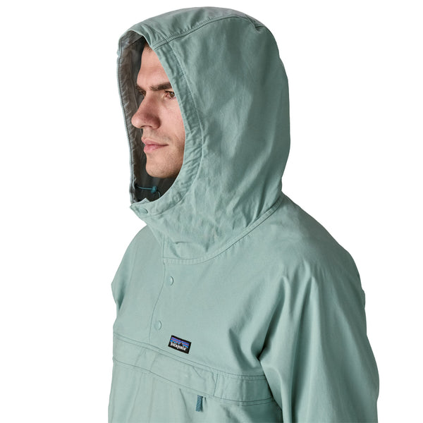 Person wearing khakis and a Patagonia Funhoggers Anorak Pullover in thermal blue featuring a hood on a white background.