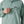 Person wearing khakis and a Patagonia Funhoggers Anorak Pullover in thermal blue featuring a front zip pocket on a white background.