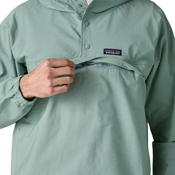 Person wearing khakis and a Patagonia Funhoggers Anorak Pullover in thermal blue featuring a front zip pocket on a white background.