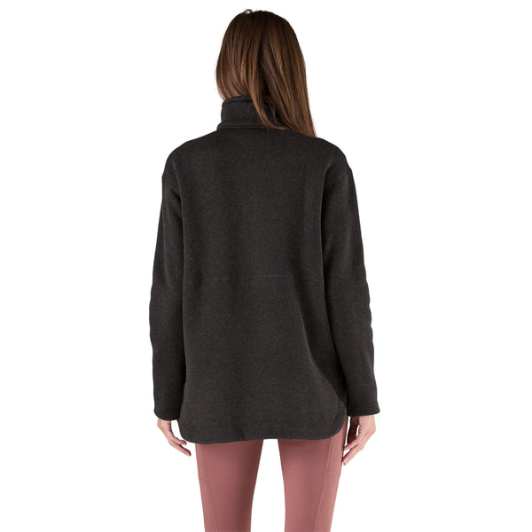 Person wearing the Patagonia Women's Better Sweater Oversized Pullover in black color with a half-zip front, stand-up collar, and a marsupial pocket on a white background.