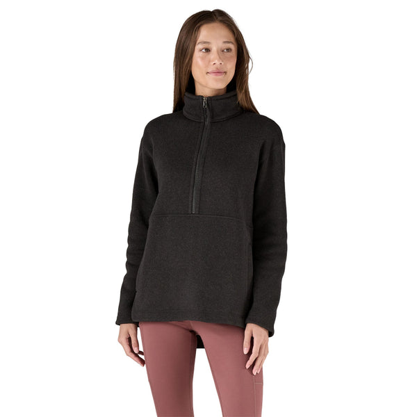 Person wearing the Patagonia Women's Better Sweater Oversized Pullover in black color with a half-zip front, stand-up collar, and a marsupial pocket on a white background.