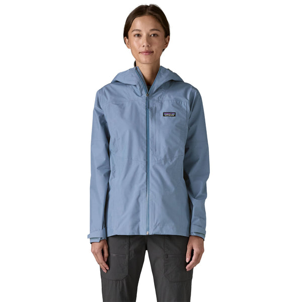 Person wearing a barnacle blue Patagonia Boulder Fork Rain Jacket on a white background.