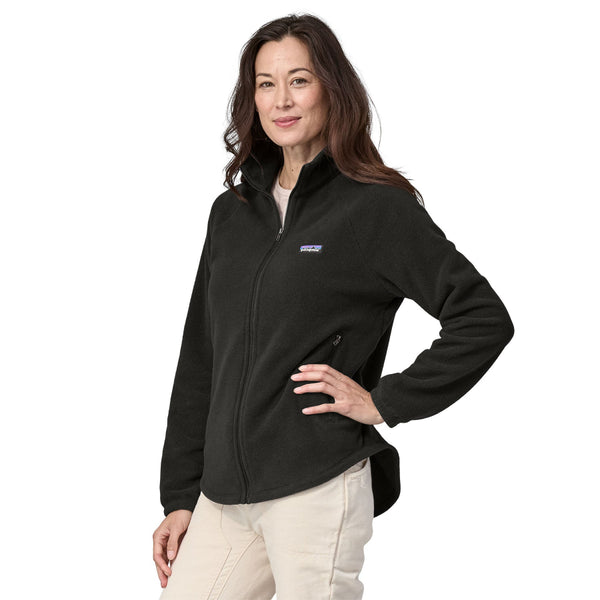 Woman wearing a black fleece Patagonia Classic Microdini Jacket on a white background.