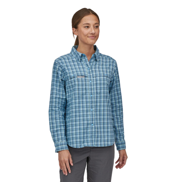 Person wearing the Patagonia Women's Early Rise Stretch Shirt in blue plaid, on a white background.