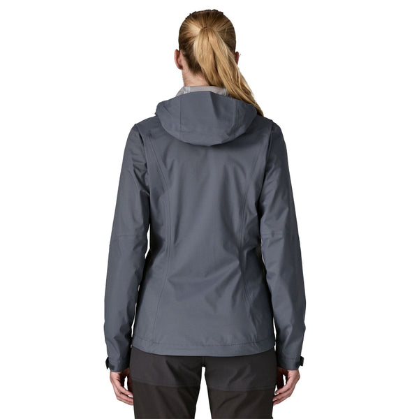 Person wearing black pants and a smolder blue Patagonia Women's Granite Crest Rain Jacket with hood, on a white background.