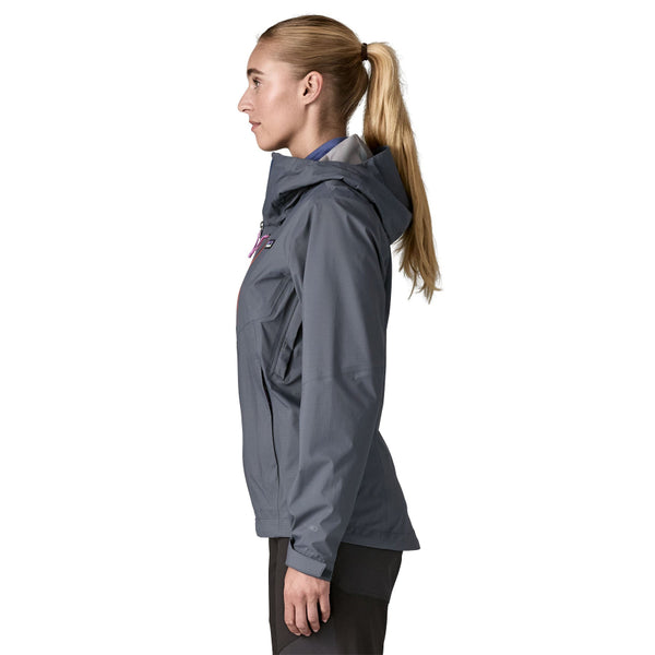 Person wearing black pants and a smolder blue Patagonia Women's Granite Crest Rain Jacket with a hood, on a white background.
