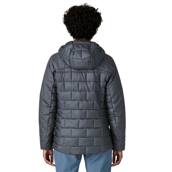 Person wearing the new for 2025 Patagonia Women's Hi-Loft Nano Puff Hoody in smolder blue on a white background.