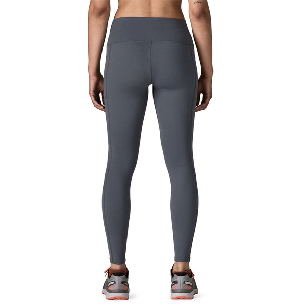 Person wearing smolder blue Patagonia Women's Maipo 7/8 Stash Tights on a white background.
