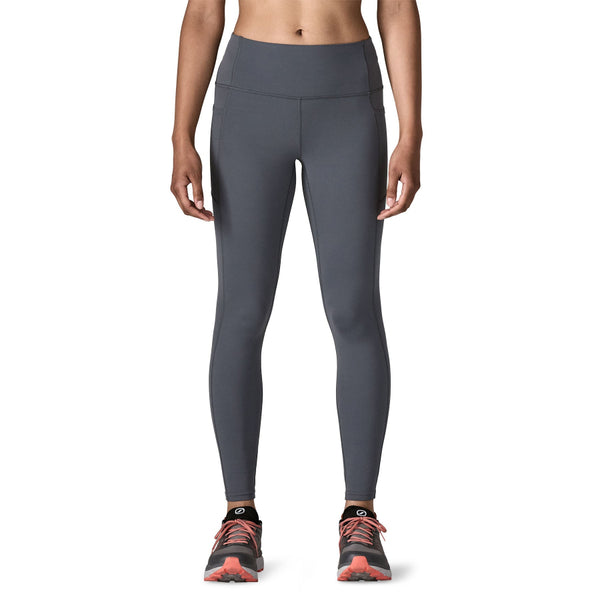 Person wearing smolder blue Patagonia Women's Maipo 7/8 Stash Tights on a white background.