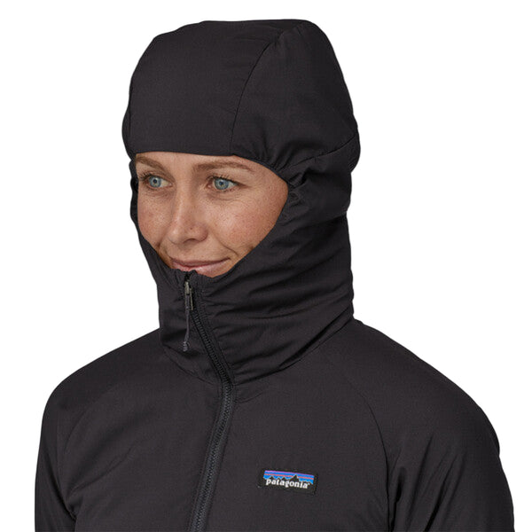 Woman wearing a black Patagonia Women's Nano Air Light Hybrid Jacket showing the hood details on a white background.
