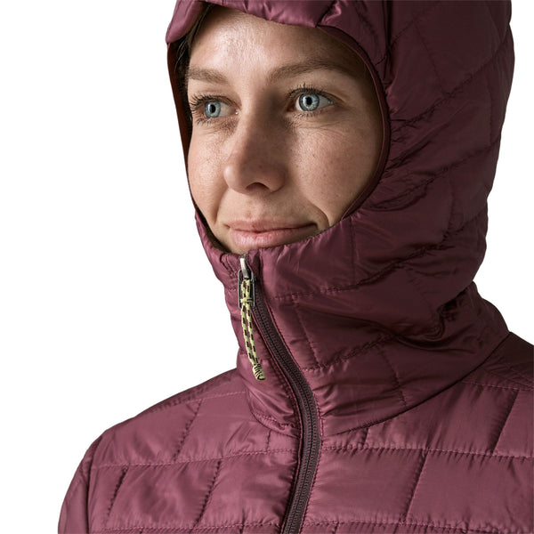 A person wearing the berry fig color Patagonia Women's Nano Puff Hoody showing the hood details, on a white background.