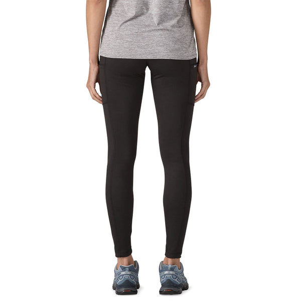 Person wearing black Patagonia Women's Pack Out Tights on a white background.